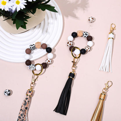 JarThenaAMCS 100Pcs Cow Print Silicone Beads Assorted Brown Black White Round Spacer Beads Keychain Making Kit with Elastic Rope Wood Key Rings and Tassels for DIY Crafts Jewelry Bracelet Pen